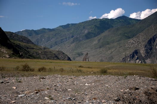 A fragment of a mountain valley with a rocky bank of the river. Altai, Siberia, Russia.