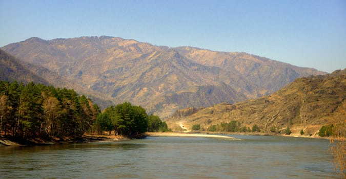 A turquoise river flowing between mountains and a picturesque valley. Katun, Altai, Russia.