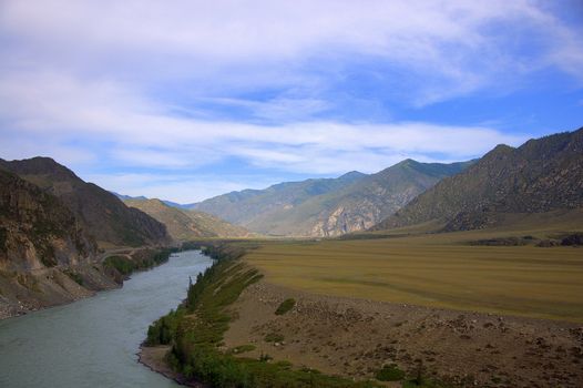 A turquoise river flowing between mountains and a picturesque valley. Katun, Altai, Russia.