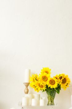 sunflower flowers on the table in a vase in the interior of a bright room