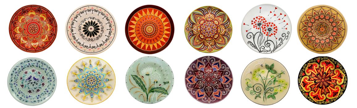 Set of decorative ceramic dishes hand-painted with acrylic paints floral pattern isolated on white background.