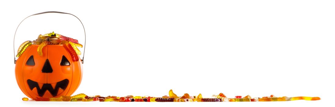 Halloween candies in Jack-O-Lantern bag isolated on white background