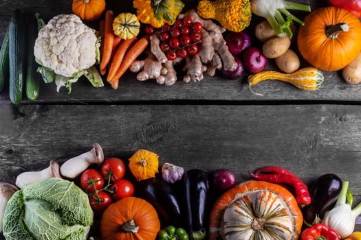 Harvest of many vegetables on rustic wooden table background border frame with copy space for text