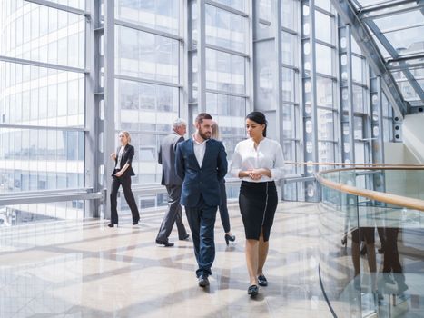 Business people walking in a modern hall of office building