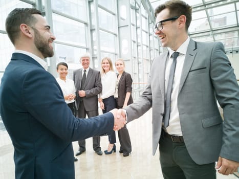 Handshake of business people in the lobby of an office building