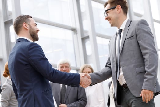 Handshake of business people in the lobby of an office building