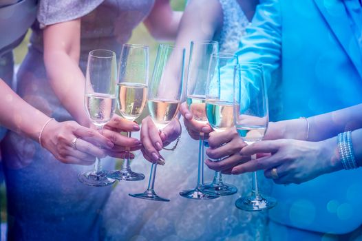 A group of young women are bumping into the glass to celebrate.