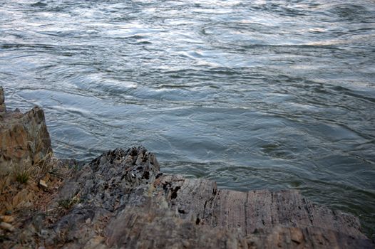 Stone on the bank of a mountain river close-up. Altai, Siberia, Russia.