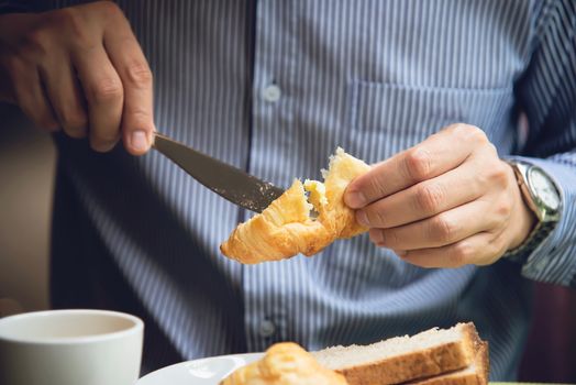 Business man eat the American breakfast set in a hotel - people take a breakfast in hotel concept