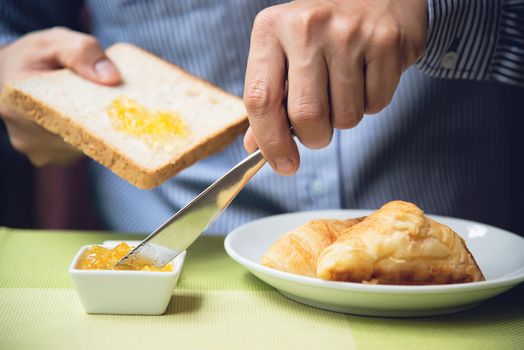 Business man eat the American breakfast set in a hotel - people take a breakfast in hotel concept