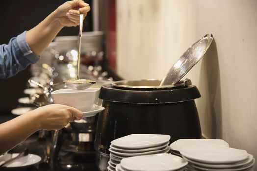 Woman eat the breakfast set in a hotel - people with breakfast in hotel concept