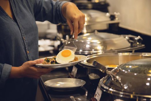 Woman eat the breakfast set in a hotel - people with breakfast in hotel concept