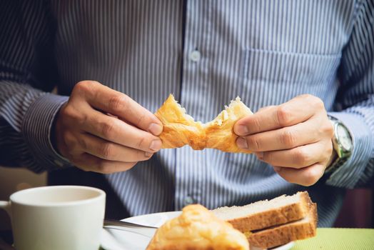 Business man eat the American breakfast set in a hotel - people take a breakfast in hotel concept