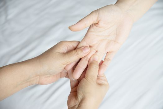 Hand spa massage over clean white bed background - people relax with hand massage service