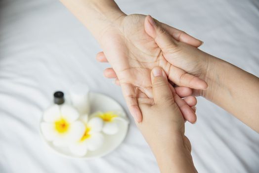 Hand spa massage over clean white bed background - people relax with hand massage service