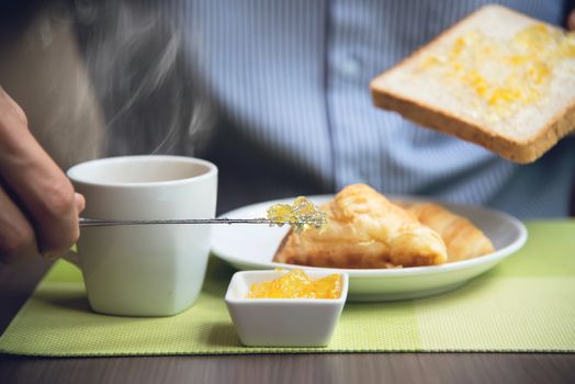 Business man eat the American breakfast set in a hotel - people take a breakfast in hotel concept