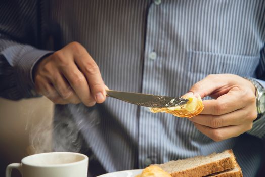 Business man eat the American breakfast set in a hotel - people take a breakfast in hotel concept