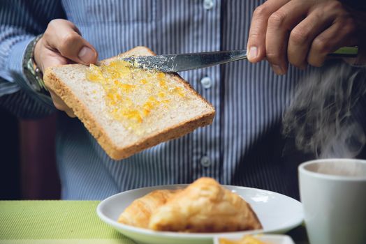 Business man eat the American breakfast set in a hotel - people take a breakfast in hotel concept