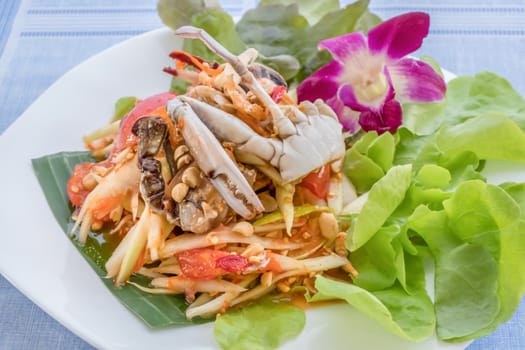 Traditional thai cuisine spicy green papaya salad with crab