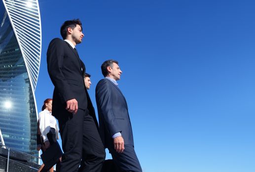 Team of diverse business people outdoors of company office building