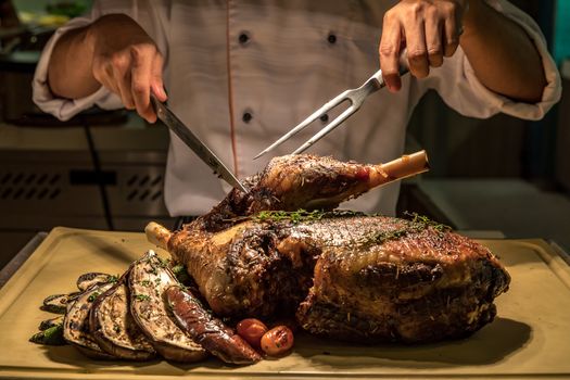 Carving of Roasted lamb meat