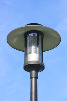 Street lamp with a large screen, blue sky in the background  Strassenlaterne mit gro�em Schirm,blauer Himmel im Hintergrund