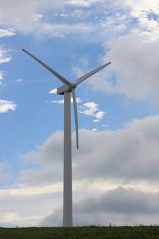 Wind turbine to generate electricity with blue sky in the background  Windrad zur Stromerzeugung mit blauem Himmel im Hintergrund