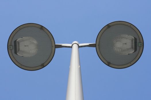 Street light with two lamps, blue sky in the background  Stra�enlaterne mit zwei Strahlern,blauer Himmel im Hintergrund