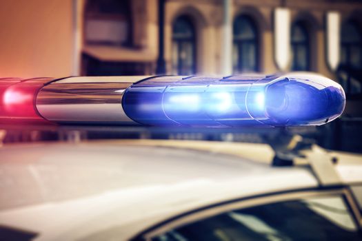 Red and blue signal lights on the roof of a traffic police patrol car.