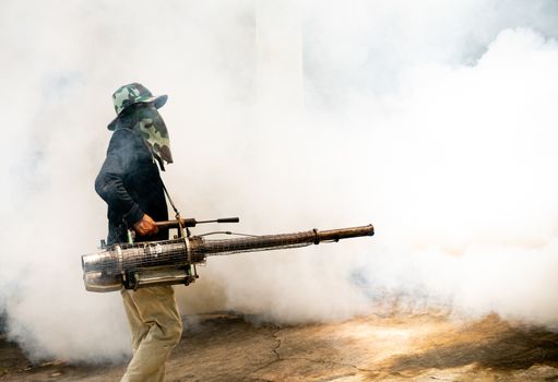 man use fumigation mosquitoes machine for kill mosquito carrier of Zika virus and dengue fever around the house