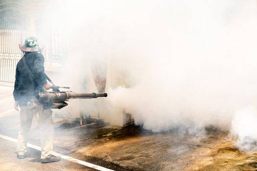 man use fumigation mosquitoes machine for kill mosquito carrier of Zika virus and dengue fever around the house