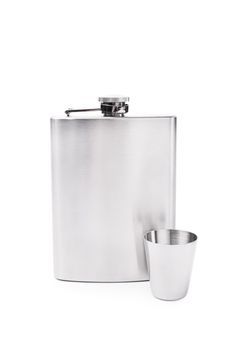 Stainless steel flask with a small metal cup, placed next to each other, isolated on white background.