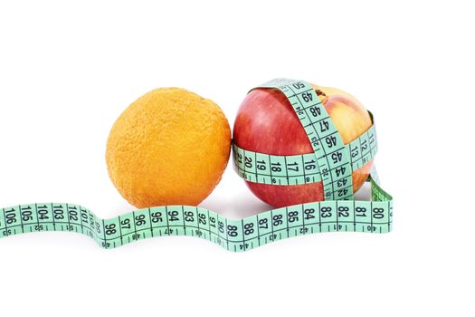 You are what you eat. Two fruits, orange and apple, on a white background. Apple wrapped in a measuring tape on a white background.
