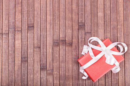 Top view of a gift box on a wooden background.