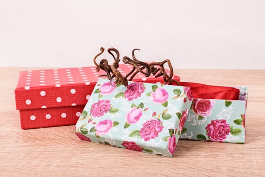 Gift boxes on a textured wooden surface.