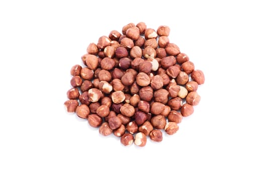 Top perspective of a heap of hazelnuts, isolated on white background.