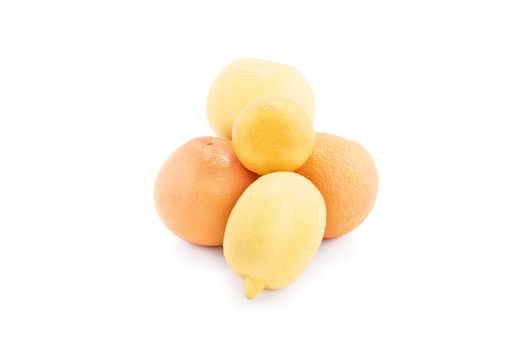 A pile of yellow and orange fruits, isolated on white background. Lemon, orange, citrus and tangerine isolated on white background.