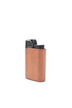 Close up shot of a lighter in brown leather cover, isolated on white background.