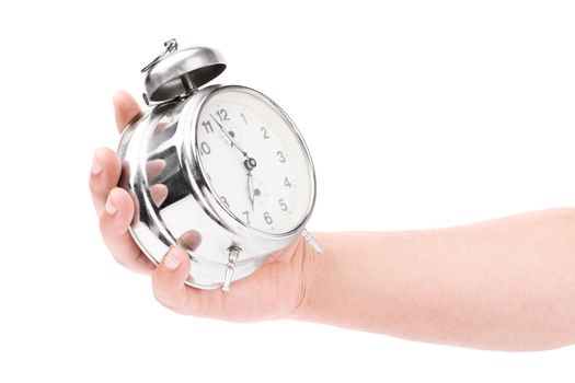 Male hand holding an old fashioned alarm clock, isolated on white background.