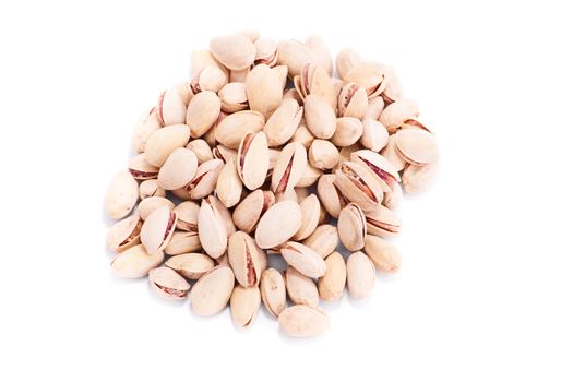 Top perspective of a heap of pistachios, isolated on white background.