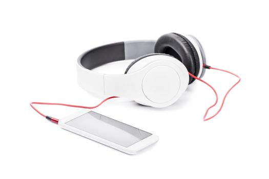 Close up of smartphone and headphones, isolated on white background.
