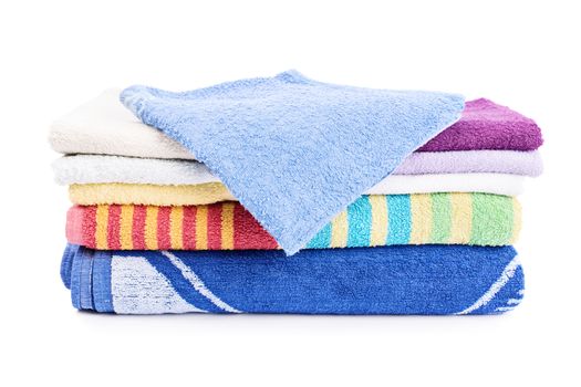 A stack of colorful folded bathroom towels, isolated on white background.