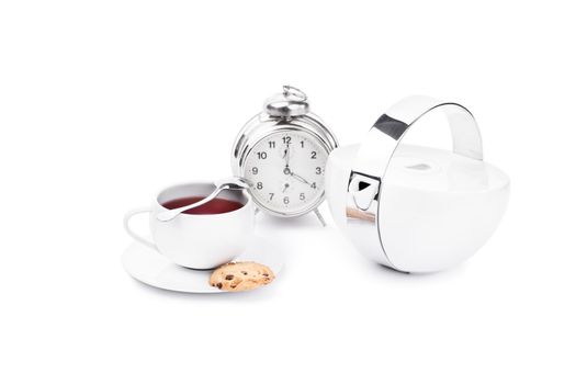 Cup of tea with chocolate cookies and an alarm clock,isolated on white background.
