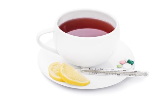 Tea with lemon, pills and thermometer, isolated on white background.
