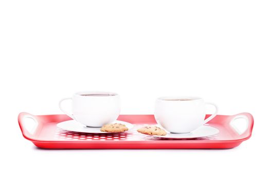 Two cups of tea with cookies on a platter, isolated on white background.