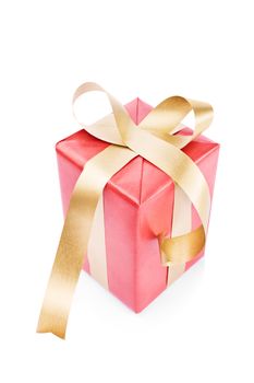 Gift wrapped in red with golden ribbon, isolated on white background.