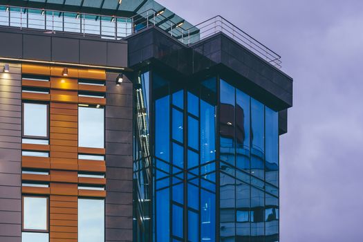 Modern high-rise office building with a glass facade, background.