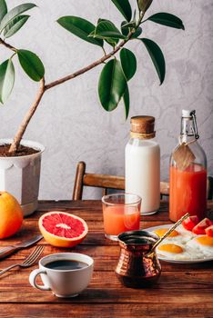 Healthy breakfast with turkish coffee, milk, juice, fried eggs, fruits and vegetables