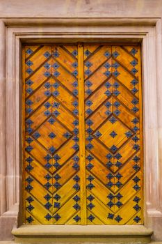 Old yellow door without a door handle in the old part of the city