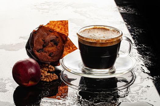 Glass cup of coffee, muffin and peach on a glass background